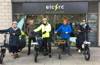 Staff of University of Brighton and Elctrc cycles in front of Elctrc shop four with electric e-bikes.