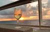 Glass of wine in the sunset on a cruise ship Photo by Reiseuhu on Unsplash