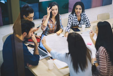Mature students working around table