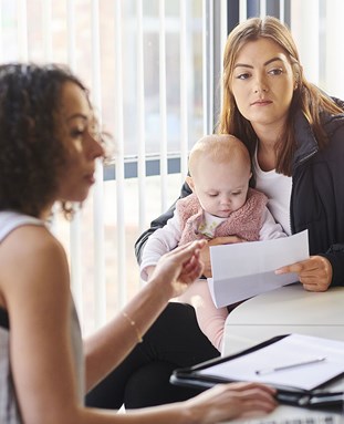 Two women and a baby in an office