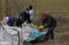 Volunteers at chalk grassland restoration bagging up debris